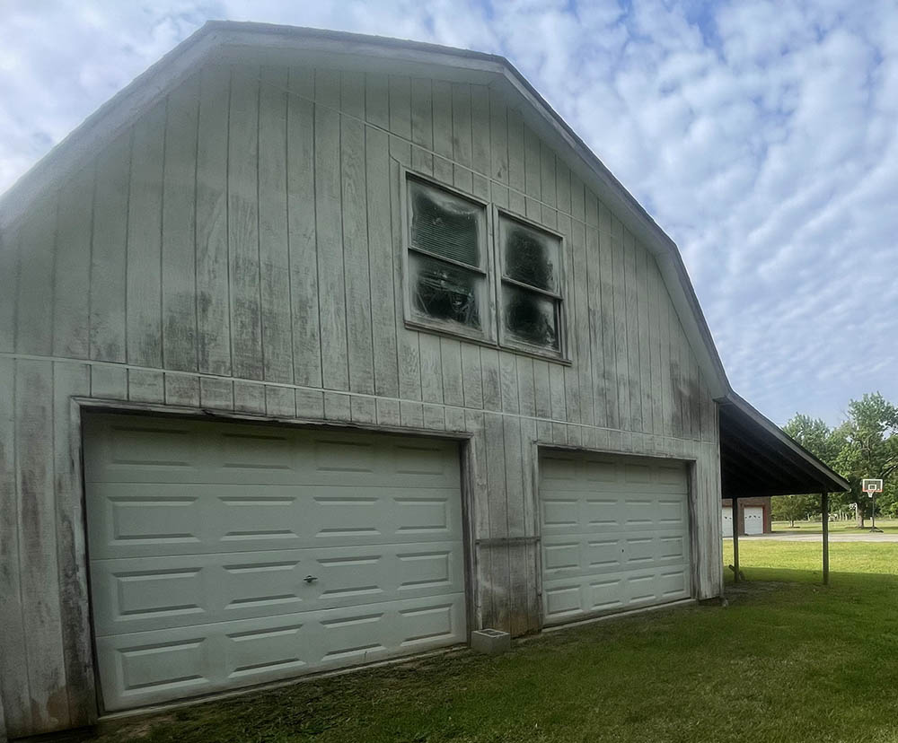 Barn showing signs of fading, chalking, and algae growth